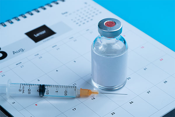Needle and formula sitting on a calender