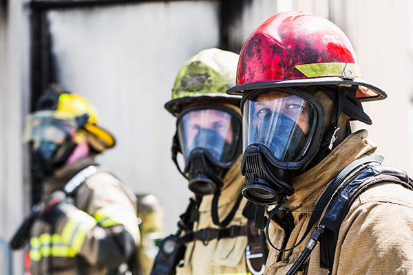 Firefighters wearing masks to protect from the smoke.