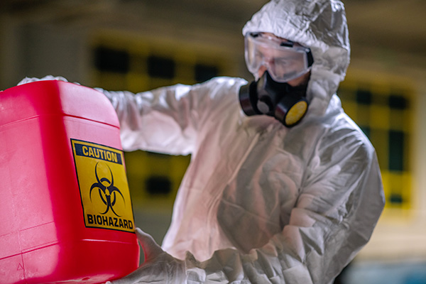 Man in hazmat suit working with hazardous chemicals