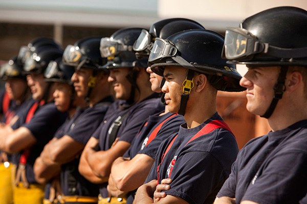 A line of firefighters listening to their leader.