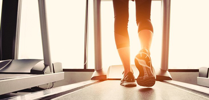 Women walking on treadmill in athletic shoes