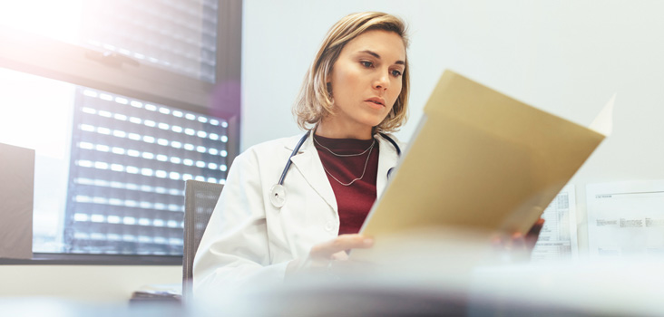 Physician reviewing a patients records for validation