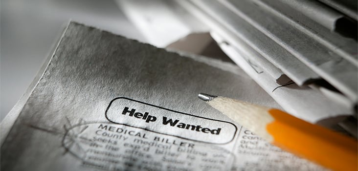"Help wanted" words circled in the paper