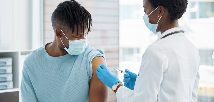 Physician injecting the flu shot into a patient.