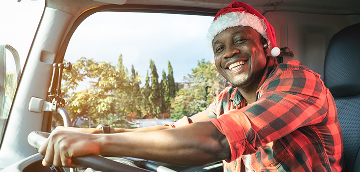 Man smiling while holing steering wheel 