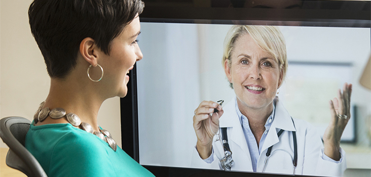 Woman videochatting with physician through television