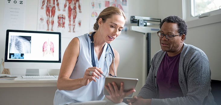 Doctor walking patient through a pre-placement exam.