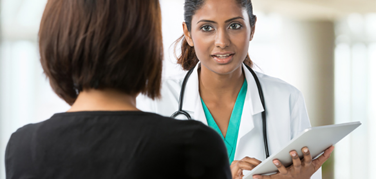 Female physician speaking to female patient